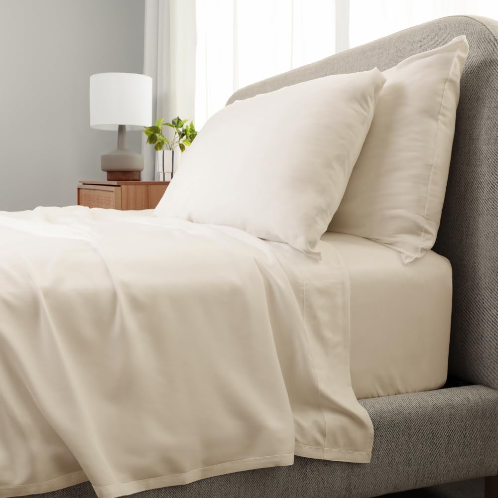 DreamCloud luxury hybrid mattress with Cariloha Aloha Soft Sheets and pillows, styled on a modern bed in a cozy bedroom setting.
