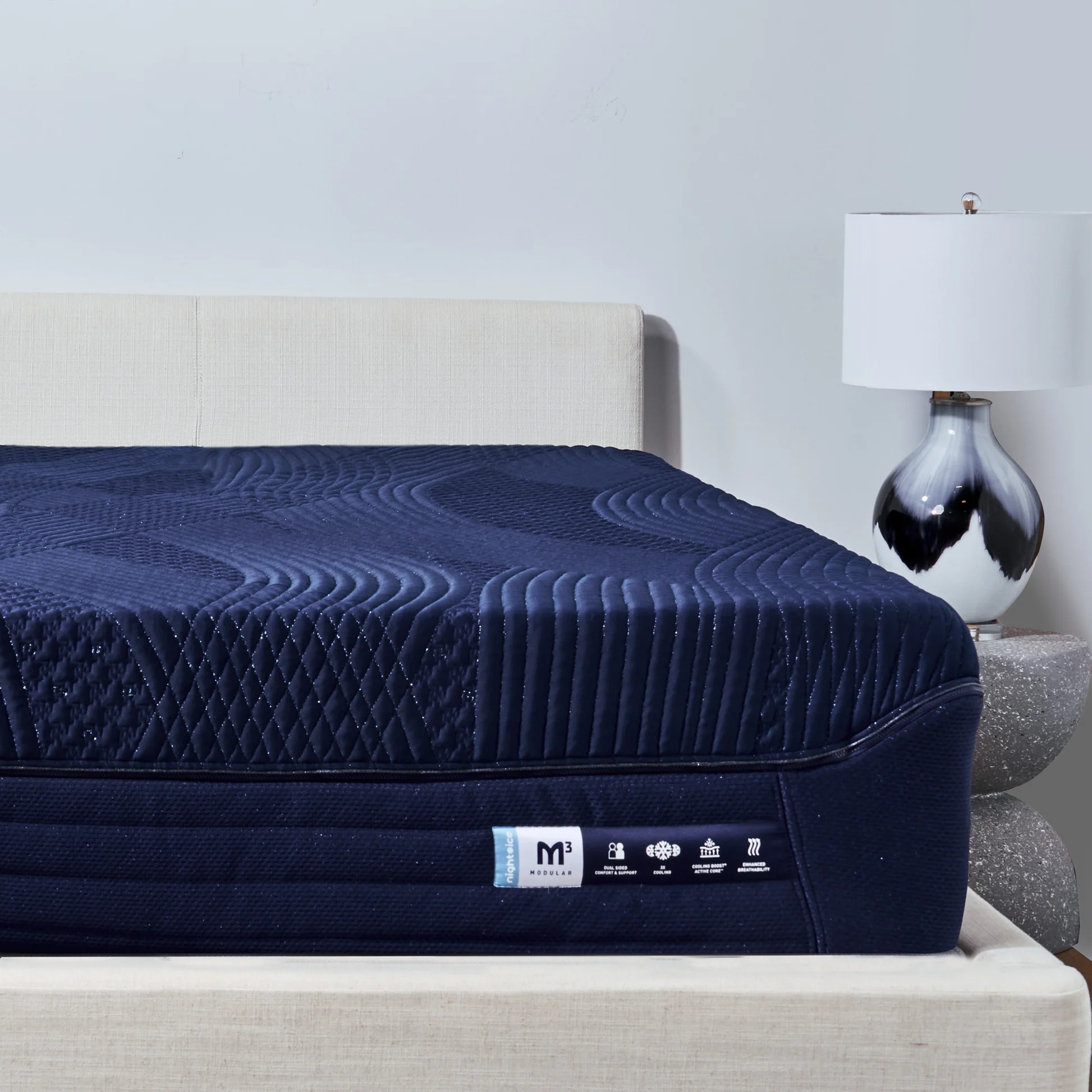 BedGear M3 Night Ice mattress on a bed frame with decorative lamp, featuring advanced cooling technology and modular design for optimal sleep comfort.