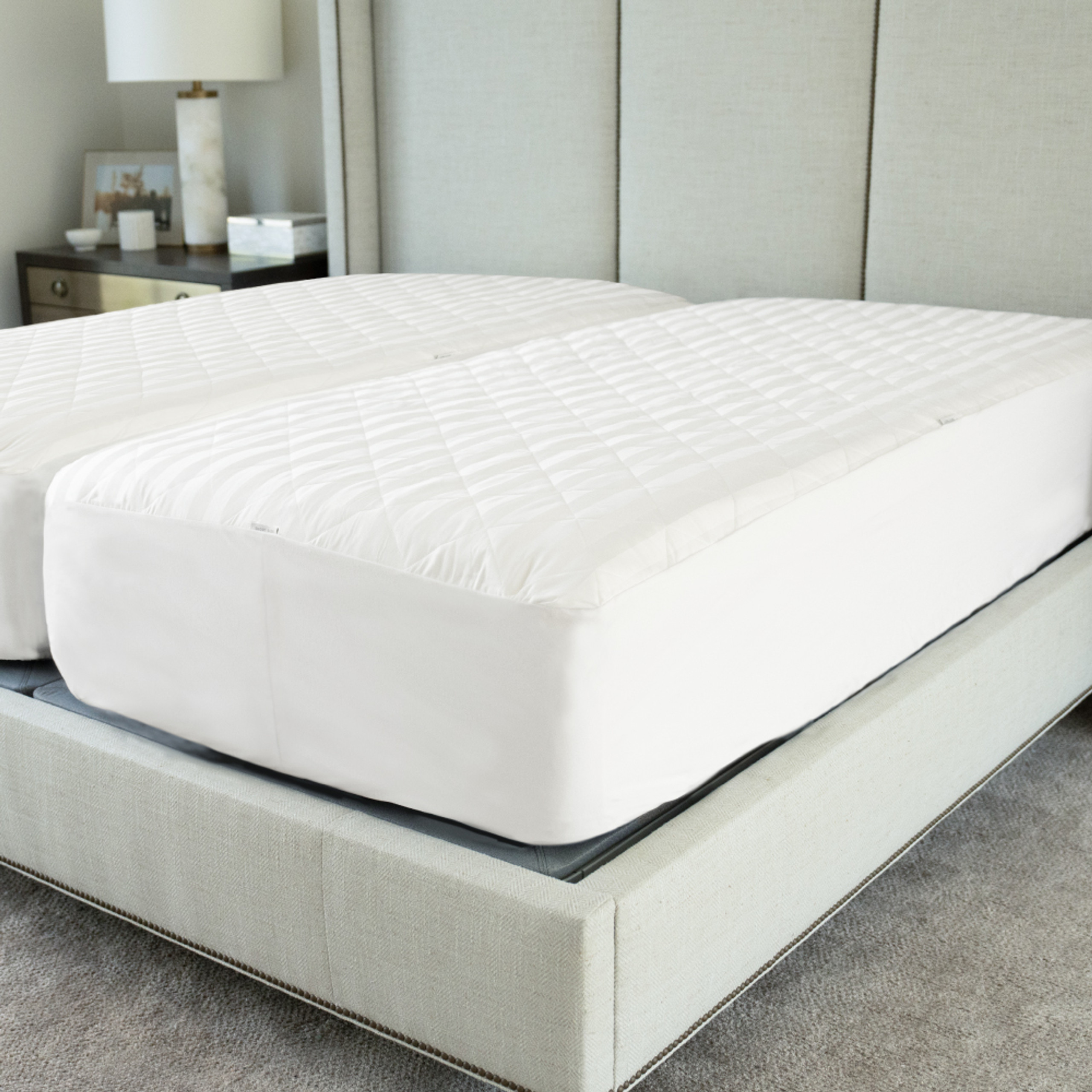 Cariloha Quilted Mattress Protector on a bed, featuring a soft, breathable bamboo fabric and waterproof design, emphasizing comfort and eco-friendliness.