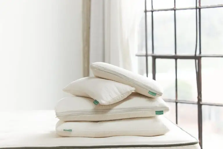 Stack of three pillows on a bed, showcasing various shapes and sizes, emphasizing comfort and support for different sleep positions.