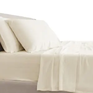 Ivory classic sheets set displayed on a bed, showcasing a soft, smooth texture, perfect for enhancing sleep comfort.